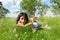 Teenage schoolgirl reading book in grass