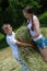 Teenage sister and little brother holding velour grass or hay