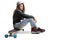 Teenage skater girl sitting on a longboard