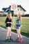 Teenage smiling happy girls having fun rollerskating, spending time together