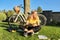 Teenage student in headphones with smartphone bicycle sitting in park