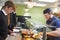 Teenage Students Being Served Meal In School Canteen