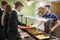 Teenage Students Being Served Meal In School Canteen