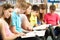 Teenage Students In Library Reading Books