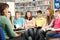 Teenage Students In Library Reading Books