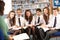 Teenage Students In Library Reading Books