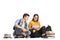 Teenage students seated on the floor studying together