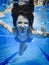 Teenage swimming underwater in the pool