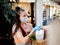 A teenage volunteer girl in a protective medical mask and protective gloves delivers a basket of essential food to the