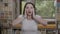 Teenage woman expressing disbelief and shock with amazed face and opened mouth covering face with hands -