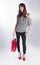 Teenage Woman Holding Single Red Shopping Bag
