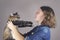 A teenaged allergic girl holds a maine coon cat