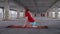 Teenaged blond girl sits on her knees on yoga mat and goes down on floor to stretch her spine and back. Outdoor yoga