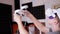 Teenager in 3D Glasses with Game Controllers Plays in a Soundproof Room