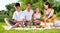 Teenager absorbed of phone during family picnic