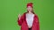 Teenager advertises a product and shows a thumbs up. Green screen