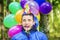Teenager with balloons in birthday party
