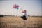 Teenager with balloons in summer field