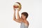 Teenager with a basketball on a white background.