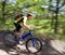 Teenager on a bicycle traveling in the forest