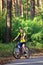 Teenager on a bicycle traveling in the woods