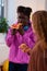 Teenager biting piece of pizza while eating with friend