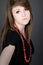 Teenager in Black Dress and Red Bead Necklace