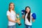 Teenager boxer winner boxing. Mommy and teenager child daughter holding winning prize, showing trophy against blue