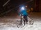 Teenager boy with bike in a winter snowy park. Kid hold handleba
