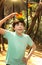 Teenager boy feeding parrot with sonflower seed funny photo