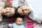 Teenager boy and his young sister lying with their newborn brother