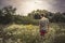 Teenager boy lonely walking summer meadow dramatic moody scenery