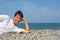 Teenager boy lying on stony seacoast