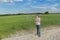 Teenager boy making soap bubbles on dusty dirt farm field road