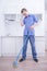 Teenager Boy Mopping The Floor and helps his parents to clean on kitchen