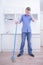 Teenager Boy Mopping The Floor and helps his parents to clean on kitchen