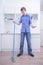 Teenager Boy Mopping The Floor and helps his parents to clean on kitchen