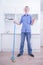 Teenager Boy Mopping The Floor and helps his parents to clean on kitchen