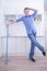 Teenager Boy Mopping The Floor and helps his parents to clean on kitchen