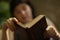 Teenager boy reading in hammock close up photo