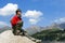 Teenager boy in red sport pullover in mountain