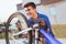 Teenager boy repair tire on bicycle