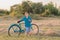 Teenager boy with retro bike in farm field