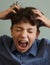 Teenager boy scratching head itch because of lice