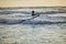 Teenager boy surfing on tropical beach in Asia. Child on surf board on ocean wave