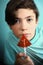 Teenager boy with water melon shape sugar candy on stick