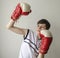 Teenager boy in a white shirt without sleeves and in boxing gloves