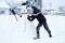 Teenager building a snowman