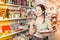 Teenager buying different products in stationery shop