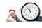 Teenager in cap of Santa Claus and large clock